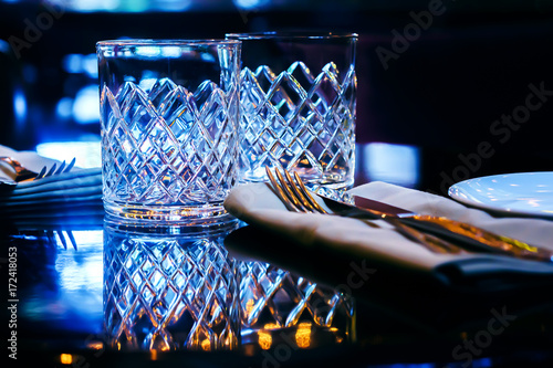 A table with glasses prepared for two persons