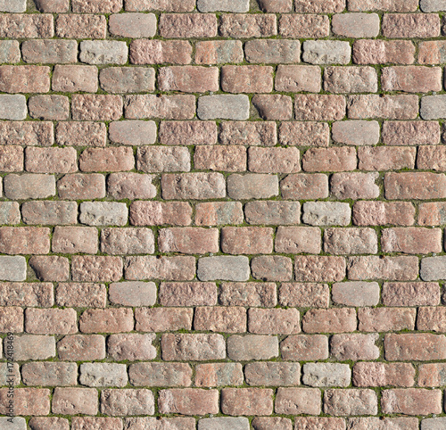 Stone pavement texture. Granite cobblestoned pavement background. Abstract background of old cobblestone pavement close-up. Seamless texture. Perfect tiled on all sides