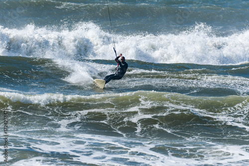 Kitesurfer riding ocean waves