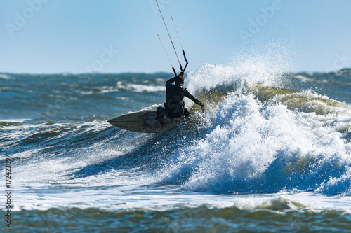 Kitesurfer riding ocean waves