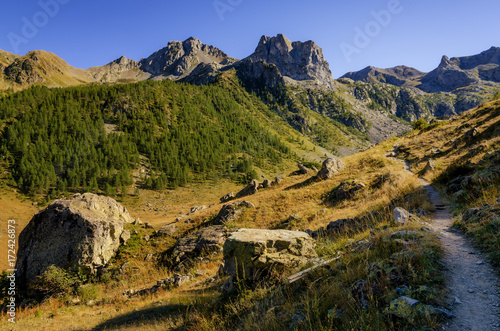 Mountain path in the park of Mercantour (France) to che Col du Fer and Lakes of Vens, at sunset photo