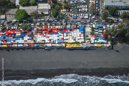 Aerial view on black sand beach and Saint-Paul market, Reunion Island, France photo