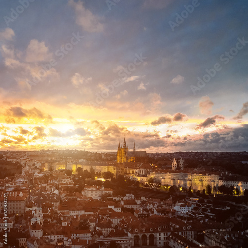 Beautiful aerial sunset view of the Prague city, panoramic view with a castle on the horizon from above. Amazing city landscape