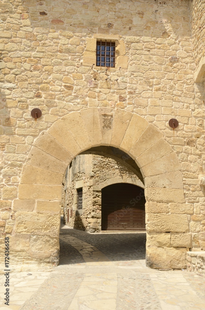 Medieval stone arch  in the medieval village of Pals, Girona, Spain