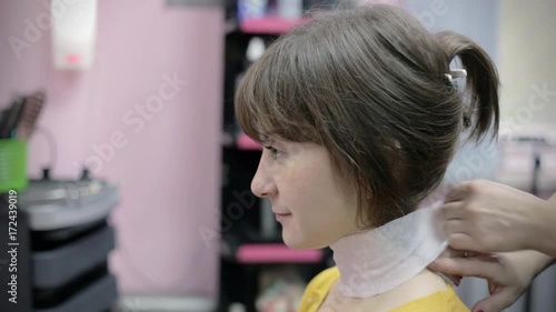 Hairdresser makes hairstyle for young girl