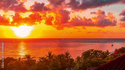 Sunrise time-lapse over the Lombok Strait to the volcano Rinjani on the island of Lombok as seen from the Amed area of eastern Bali, Indonesia. photo