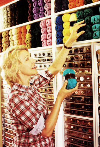 Woman picking colorful various yarn