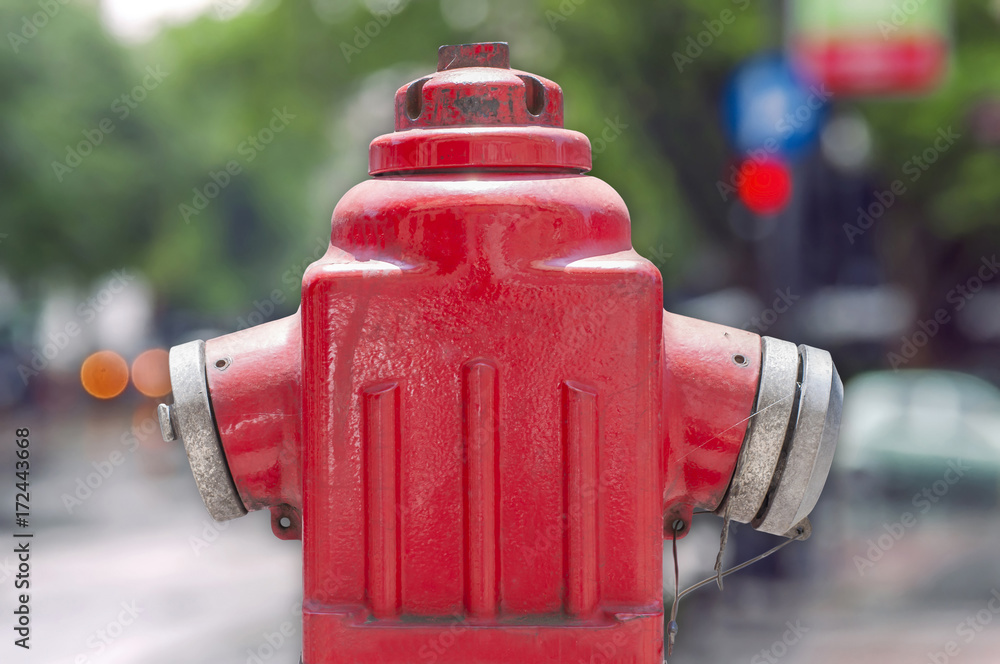 Red metallic fire hydrant or Fire Department Connection isolated on street bokeh background Red metallic fire hydrant or Fire Department Connection isolated on street bokeh background