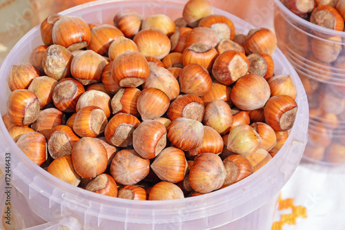 Photos Hazelnuts in plastic buckets at the market