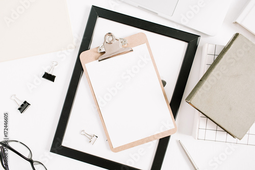 Modern home office desktop with clipboard, pen, book. Flat lay, top view business concept.