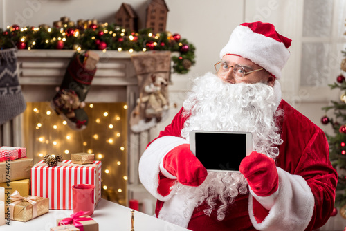 Santa Claus holding a tablet © Yakobchuk Olena