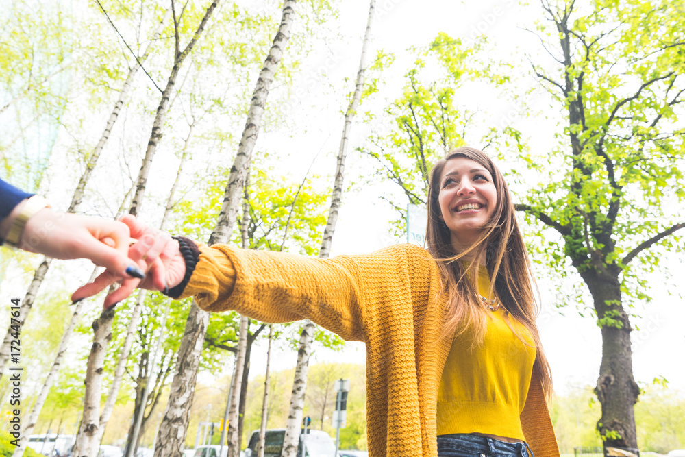 Fototapeta premium Happy woman walking with her girlfriend and smiling