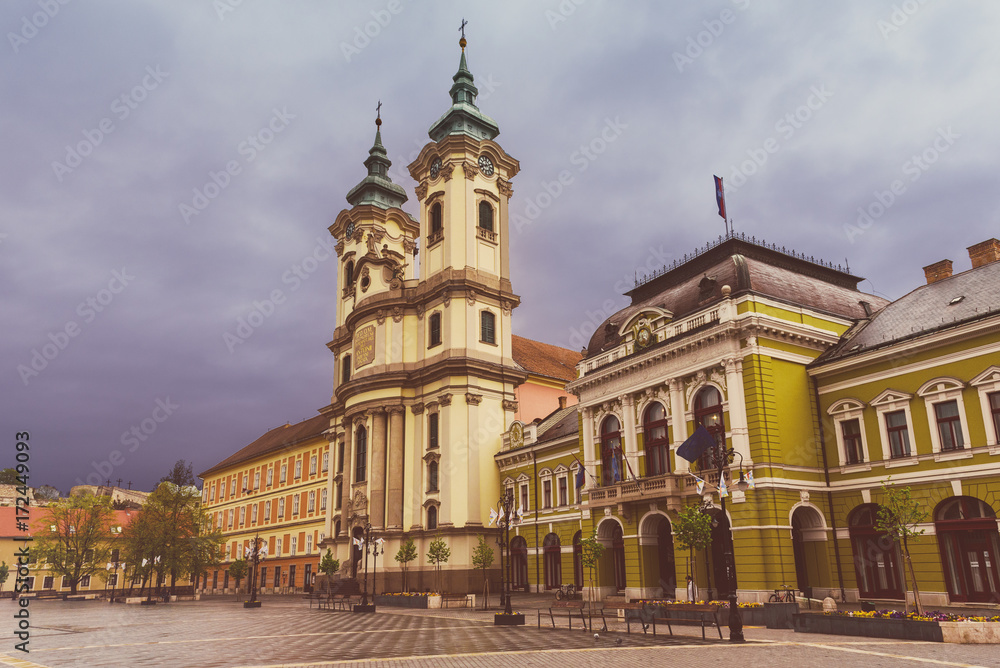 Eger main square in Hungary, Europe with dark moody sky and catholic cathedral. Travel outdoor european background