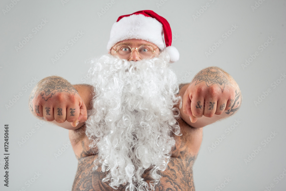 Man with tattoos wearing Christmas hat and beard Man with tattoos wearing Christmas hat and beard