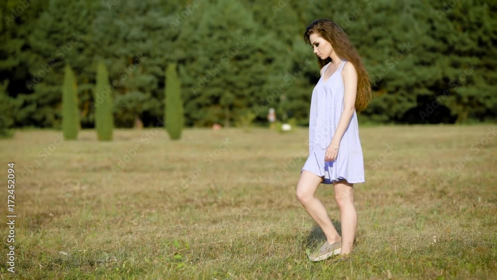 Incredible beautiful woman wondering around in field alone enjoying the last summer days and being happy Incredible beautiful woman wondering around in field alone enjoying the last summer days and being happy