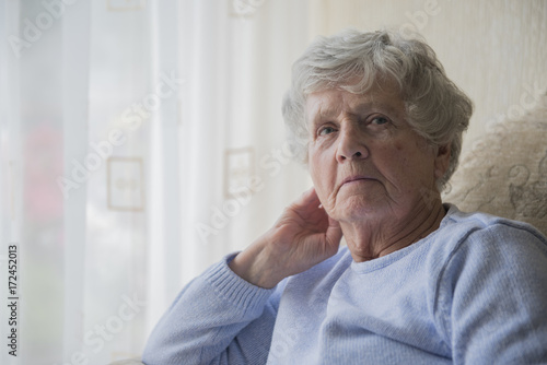 Senior woman indoors looking upset and bored 