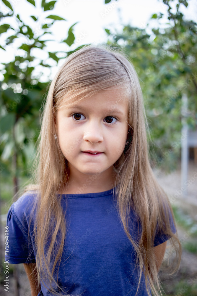 Young little girl without a front tooth in the countryside Young little girl without a front tooth in the countryside