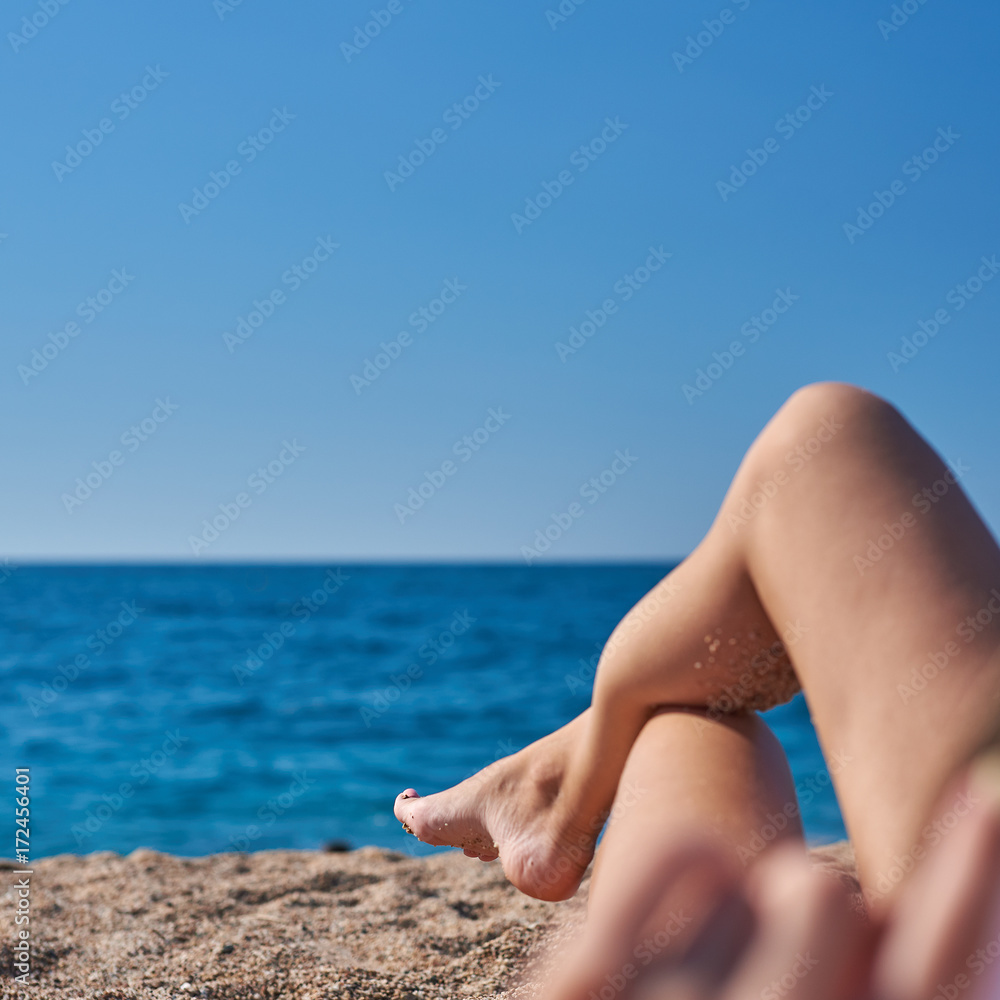 Woman in bonnet hat relaxing on the beach. Woman in bonnet hat relaxing on the beach.