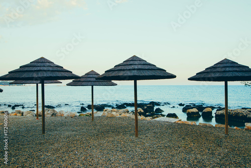 Colorful wooden beach chairs with sun umbrella