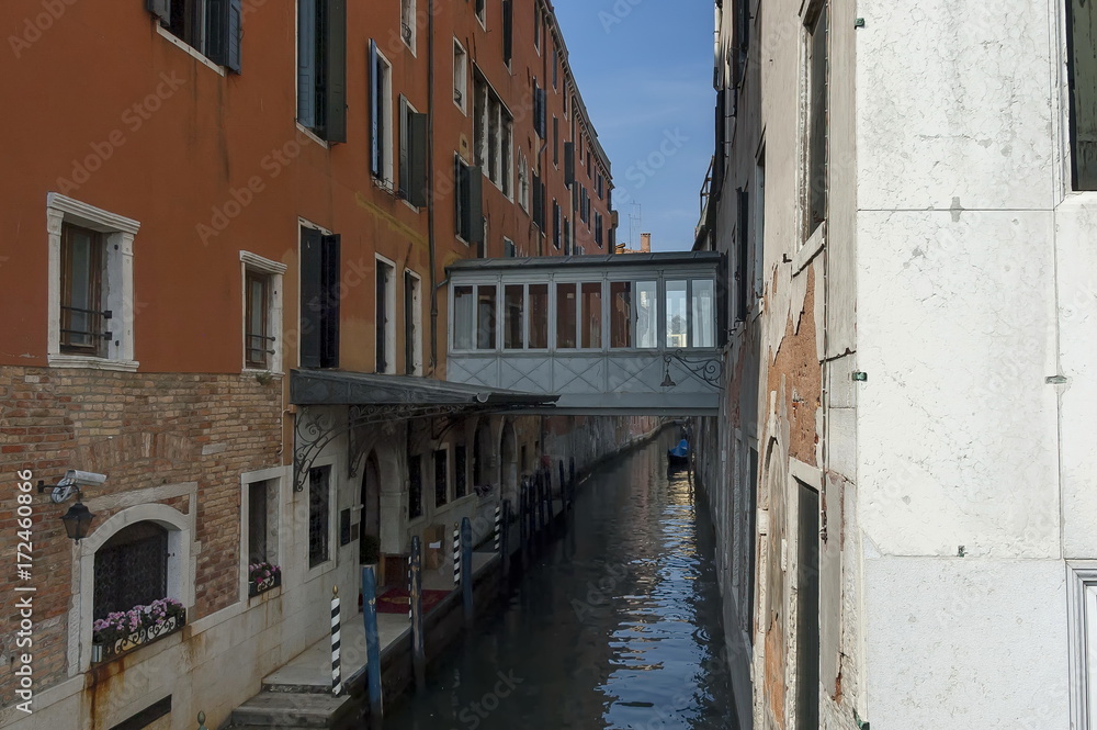 Traditional gondola ride in small canal at residential district of historical buildings and bridge, Venezia, Venice, Italy, Europe