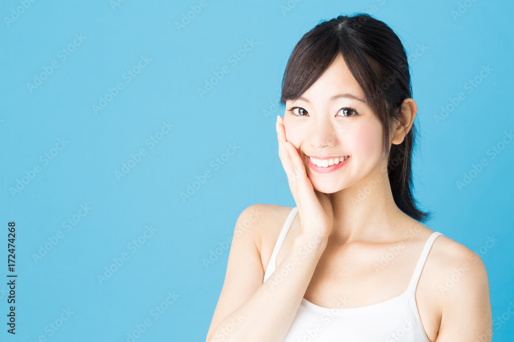 attractive asian woman beauty image isolated on blue background attractive asian woman beauty image isolated on blue background