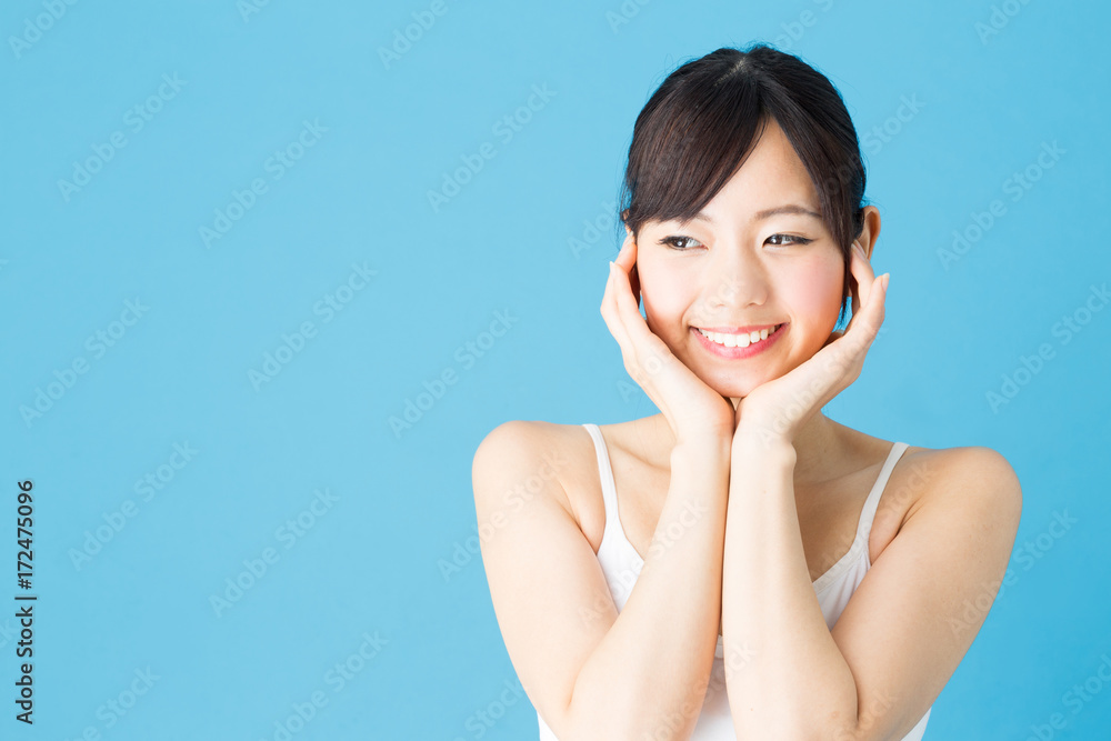 attractive asian woman beauty image isolated on blue background attractive asian woman beauty image isolated on blue background