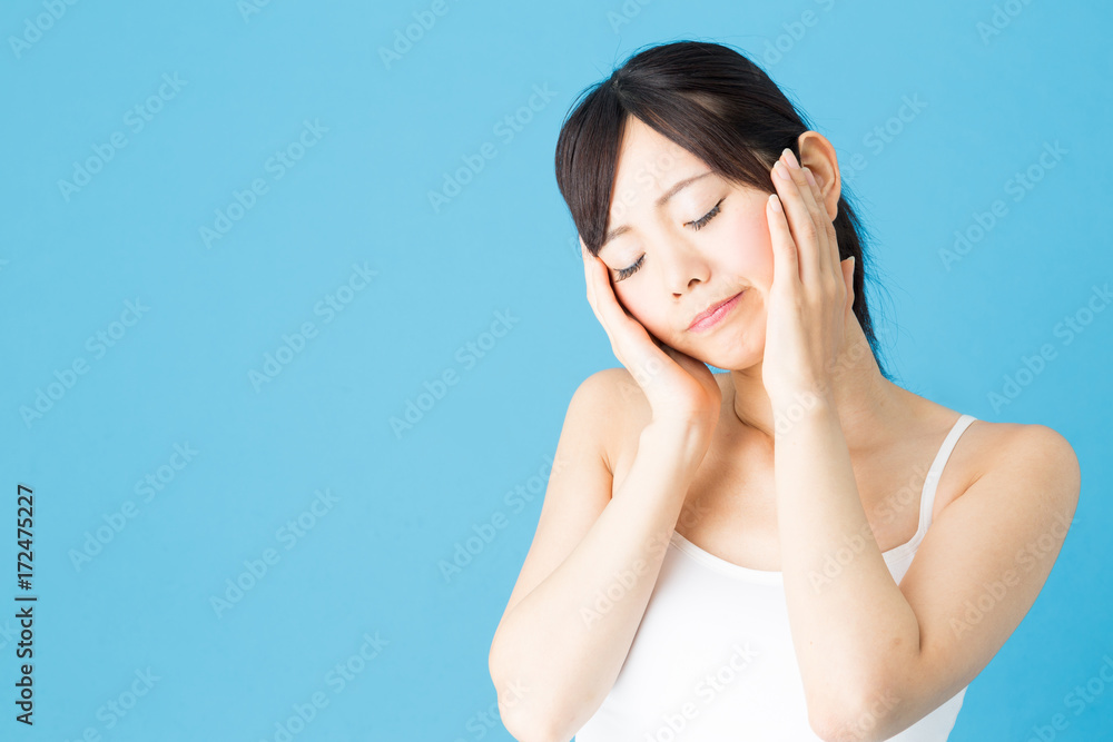 attractive asian woman beauty image isolated on blue background attractive asian woman beauty image isolated on blue background