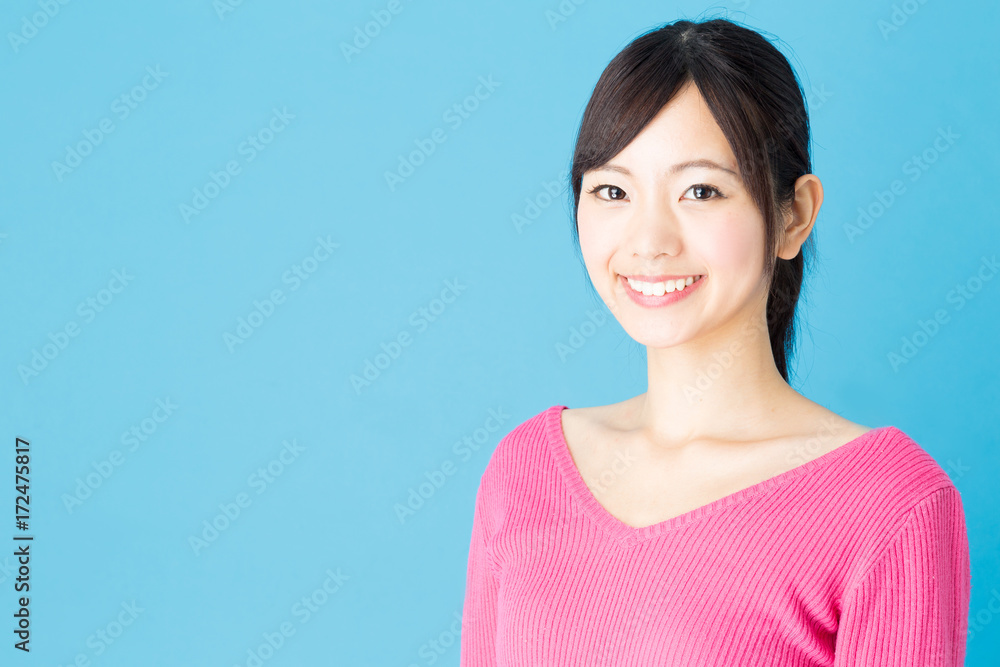 portrait of young asian woman isolated on blue background portrait of young asian woman isolated on blue background
