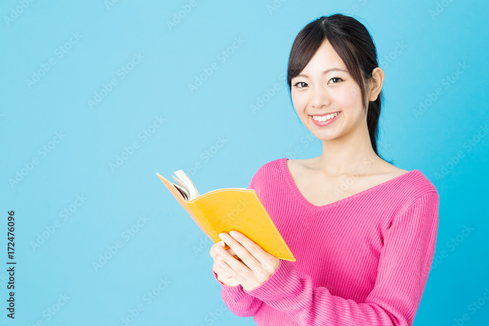 portrait of young asian woman isolated on blue background portrait of young asian woman isolated on blue background