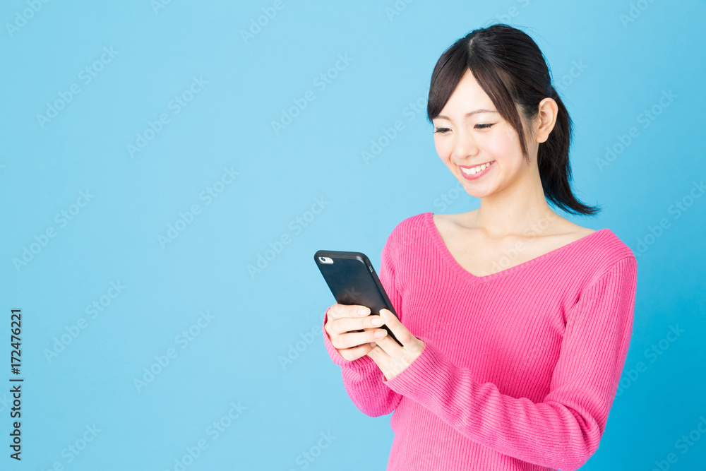 portrait of young asian woman isolated on blue background portrait of young asian woman isolated on blue background