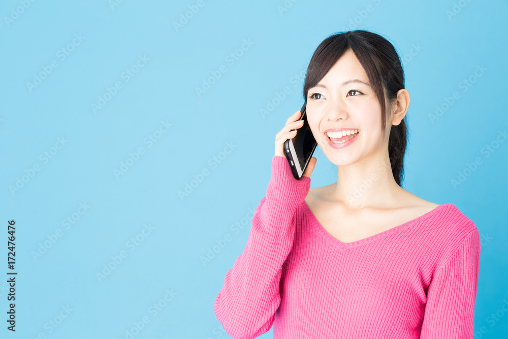 portrait of young asian woman isolated on blue background portrait of young asian woman isolated on blue background