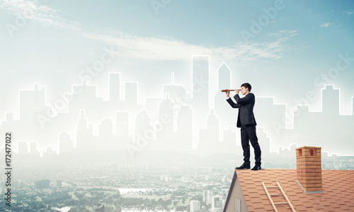 Engineer man standing on roof and looking in spyglass. Mixed med © adam121