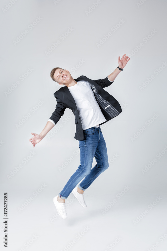 handsome man in jeans and jacket jumping handsome man in jeans and jacket jumping