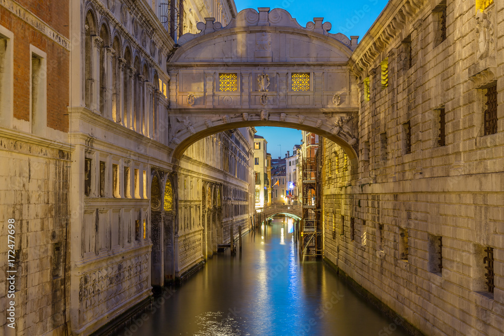 Bridge of Sighs Ponte dei Sospiri illumitaed at blue hour sunset night in Venice, Italy. Famous landmark.