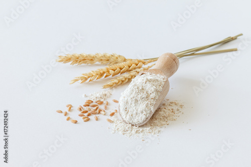 wholemeal flour in wooden spoon