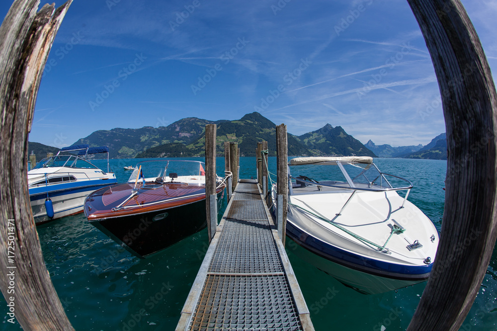 Powerboats moored to a quay in lake Lucerne