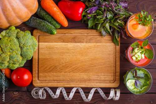 Diet concept, healthy lifestyle, low calorie detox and dietary food, kitchen background. Set of blended vegetable smoothies in glasses with ingredients and measuring tape on kitchen table, copy space