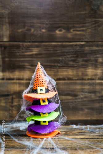 Halloween card concept with cute little witch hats on spider web