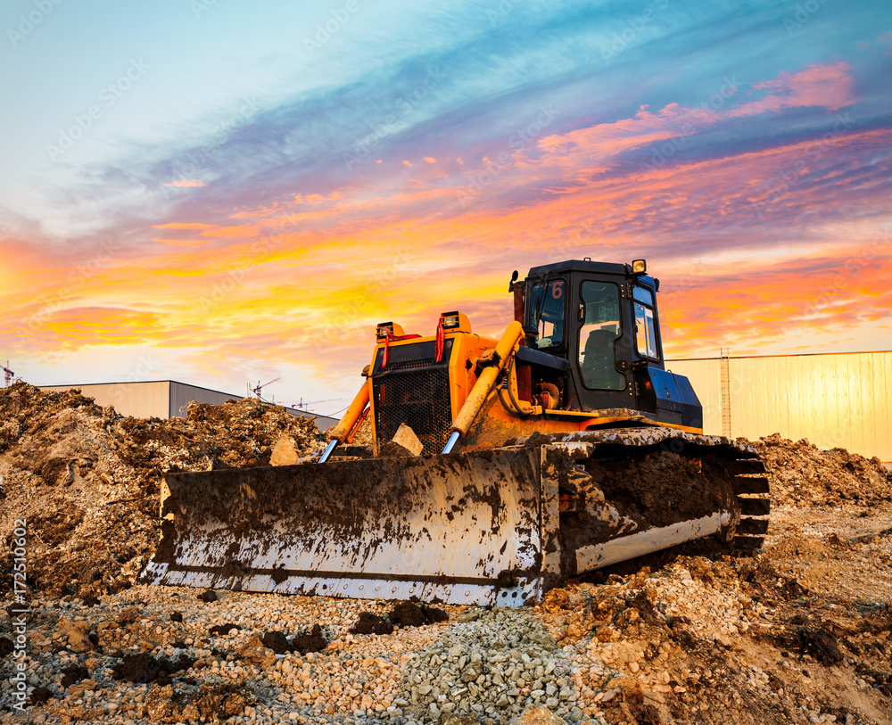 bulldozer on a building site at sunset bulldozer on a building site at sunset