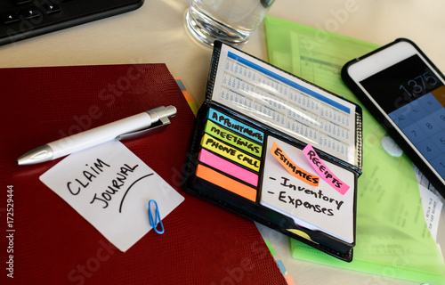Claim repairs and Insurance claim payment organization after disaster claim home damage documents and calculator on desk