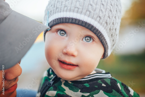 close up portrait of baby boy in cap in autunmn outdoor photo