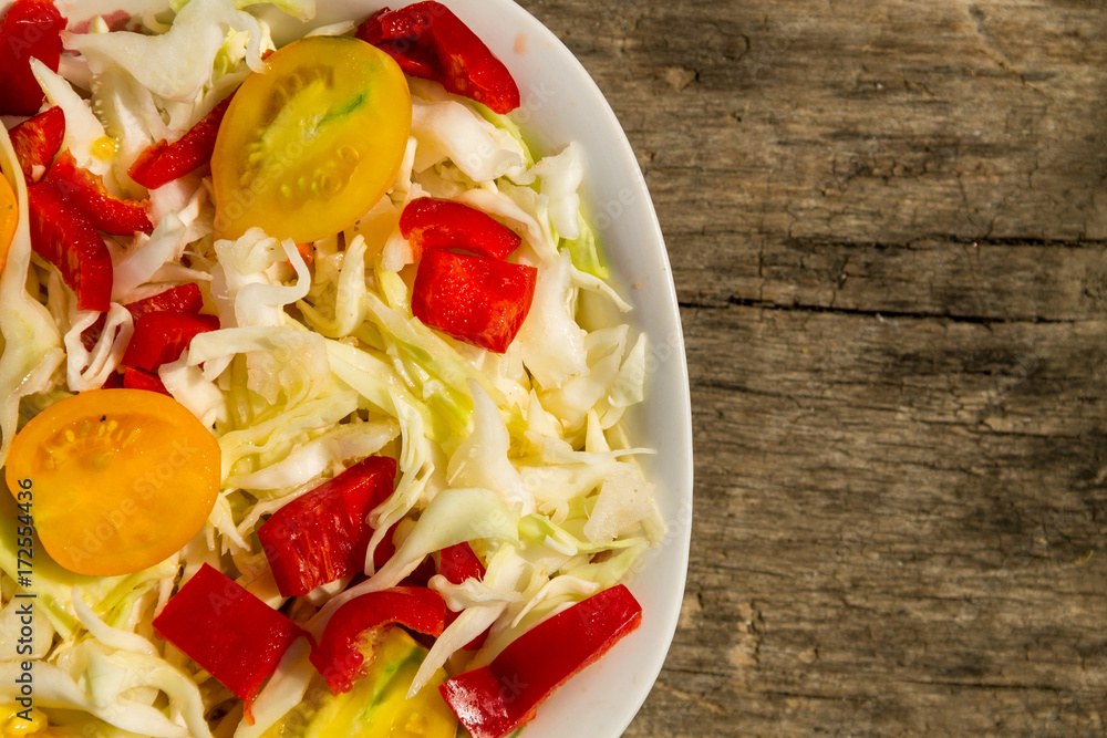 Fresh vegetable salad on rustic wooden table Fresh vegetable salad on rustic wooden table