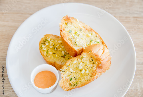 Garlic and herb bread on wooden table