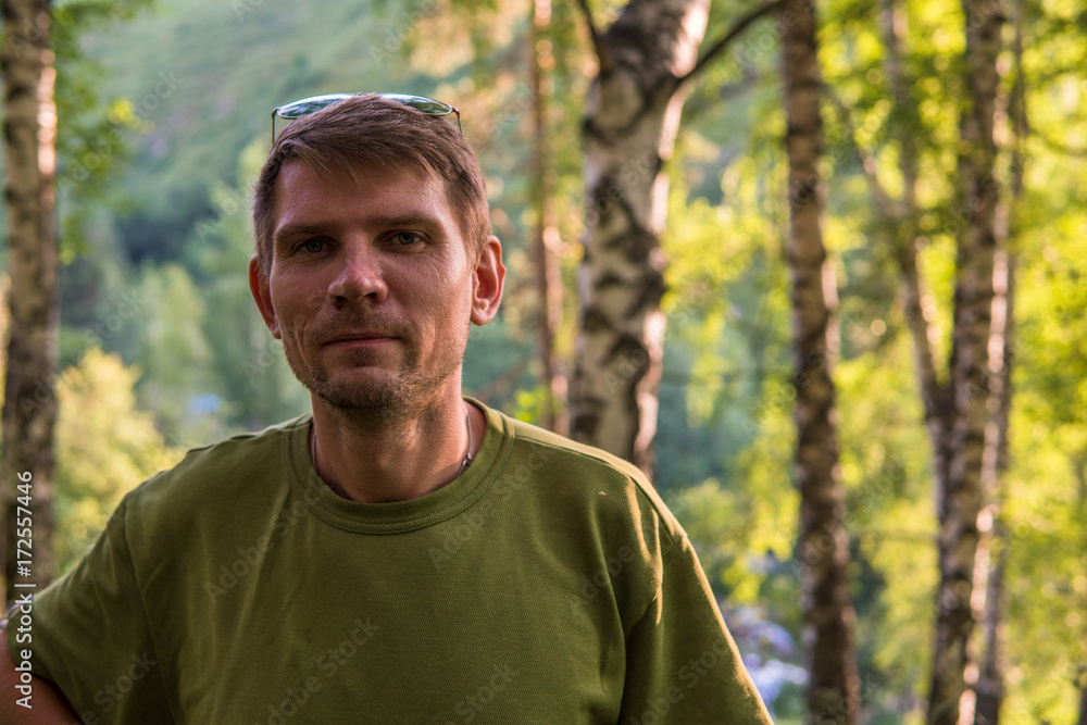 Young stylish man in summer forest in the mountains near Almaty city Young stylish man in summer forest in the mountains near Almaty city