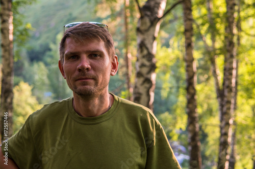 Young stylish man in summer forest in the mountains near Almaty city