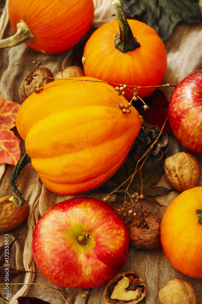Autumn pumpkins and apples with fall leaves. Autumn composition