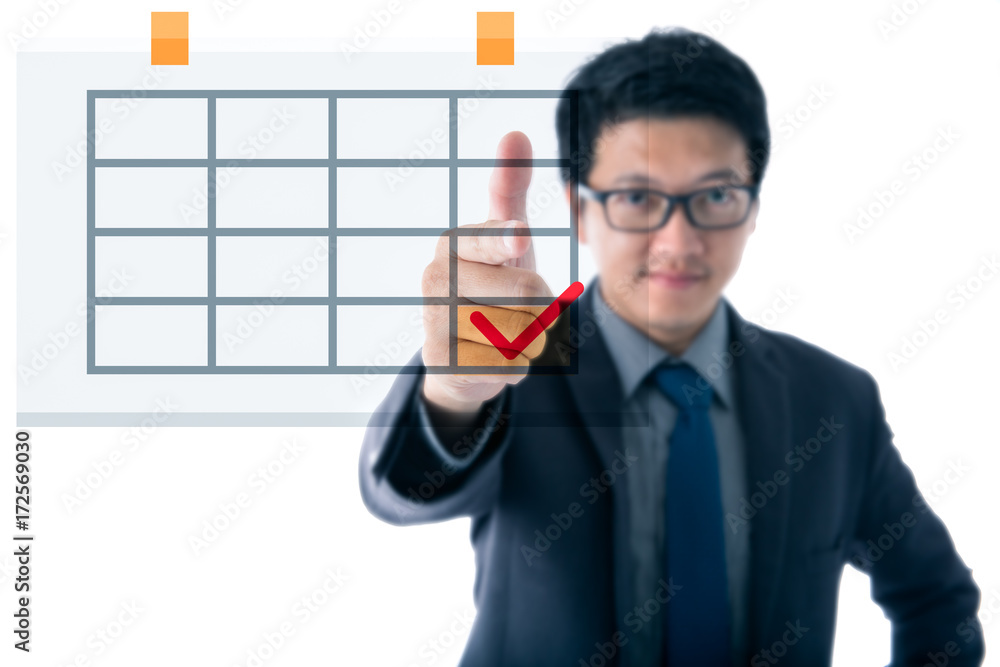Asian young business man pointing finger to calendar on white background Asian young business man pointing finger to calendar on white background