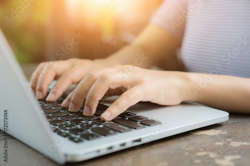 Woman working at home office hand on keyboard close up, Selective focus