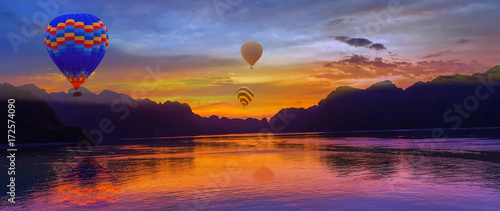 Hot air balloon flying over rock landscape