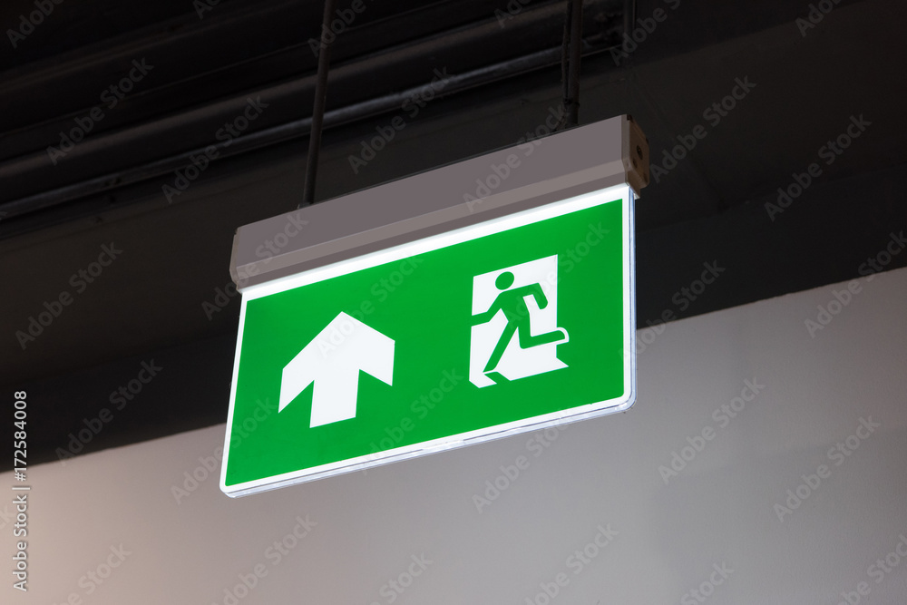 green emergency exit sign showing the way to escape. green emergency exit sign showing the way to escape.